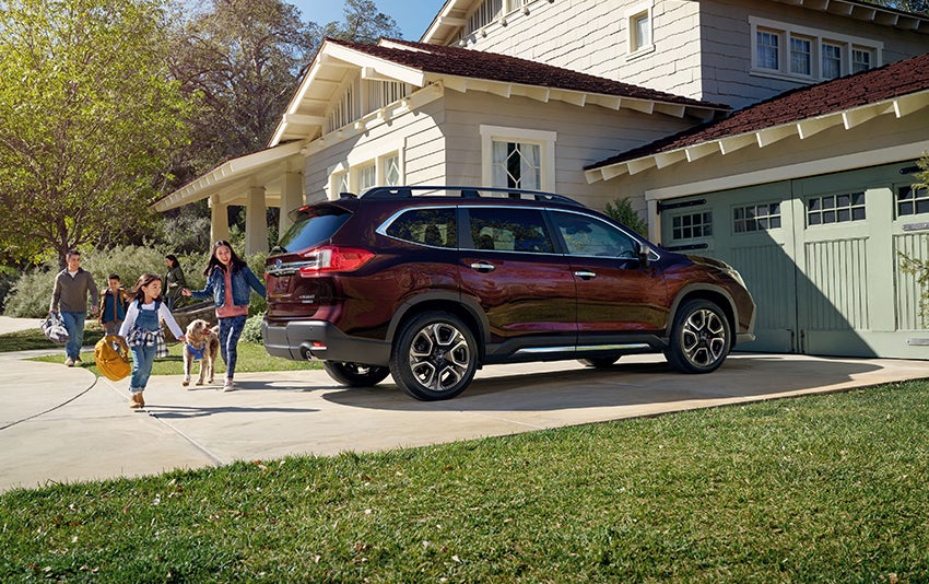 A new Ascent parked in a drive with a family.