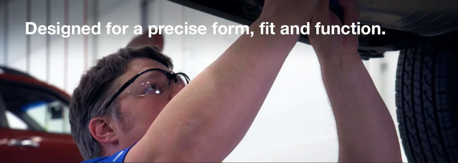 A Subaru technician under a Subaru vehicle with title Designed for a precise form, fit and function.