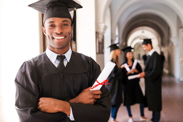 college graduate holding his diploma | Subaru of Columbia in Columbia MO