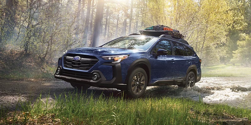 Front side view of Subaru Outback driving off-road