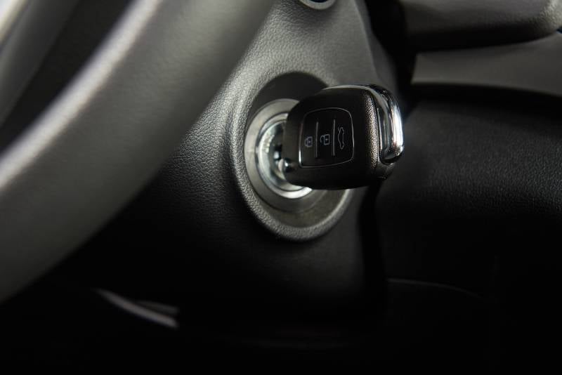 Car key inserted into vehicle ignition switch